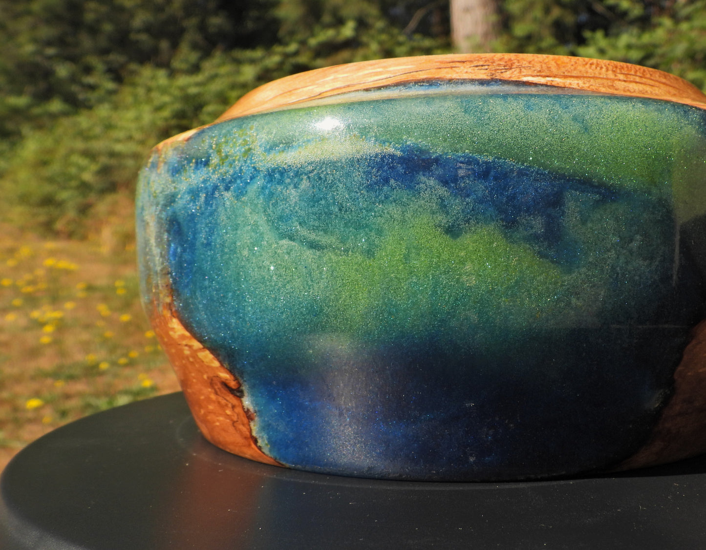 Side view of Wood and epoxy resin bowl in Seahawks football blue and green colors