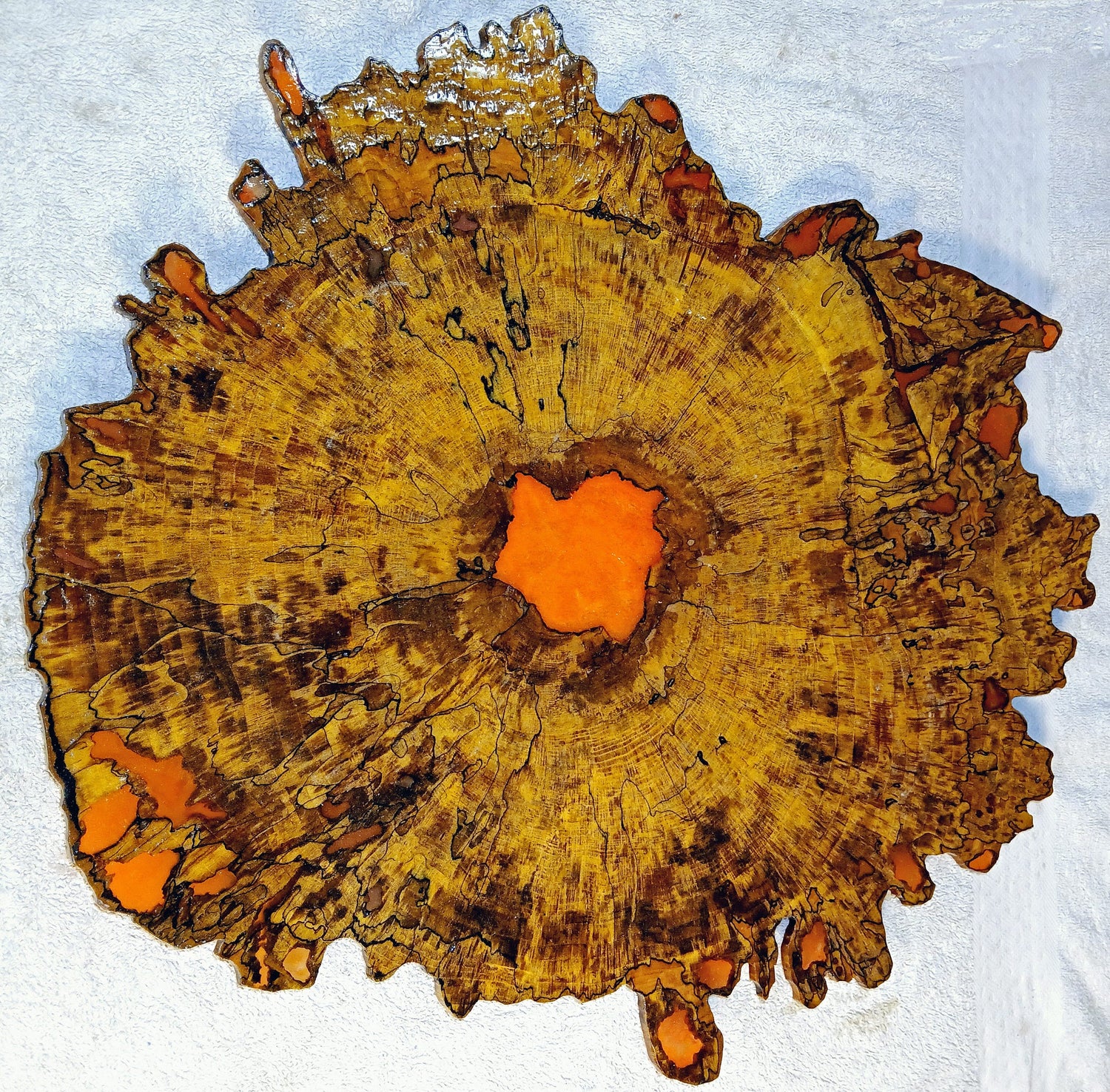 A colorful and vibrant wood and epoxy resin sculptured art piece made with maple hardwood.