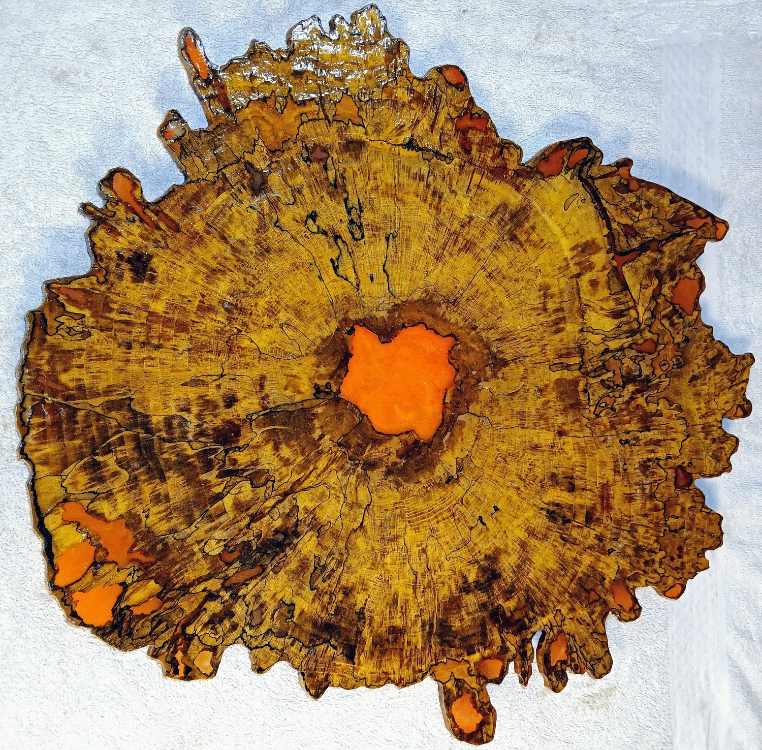 A colorful and vibrant wood and epoxy resin sculptured art piece made with maple hardwood. 