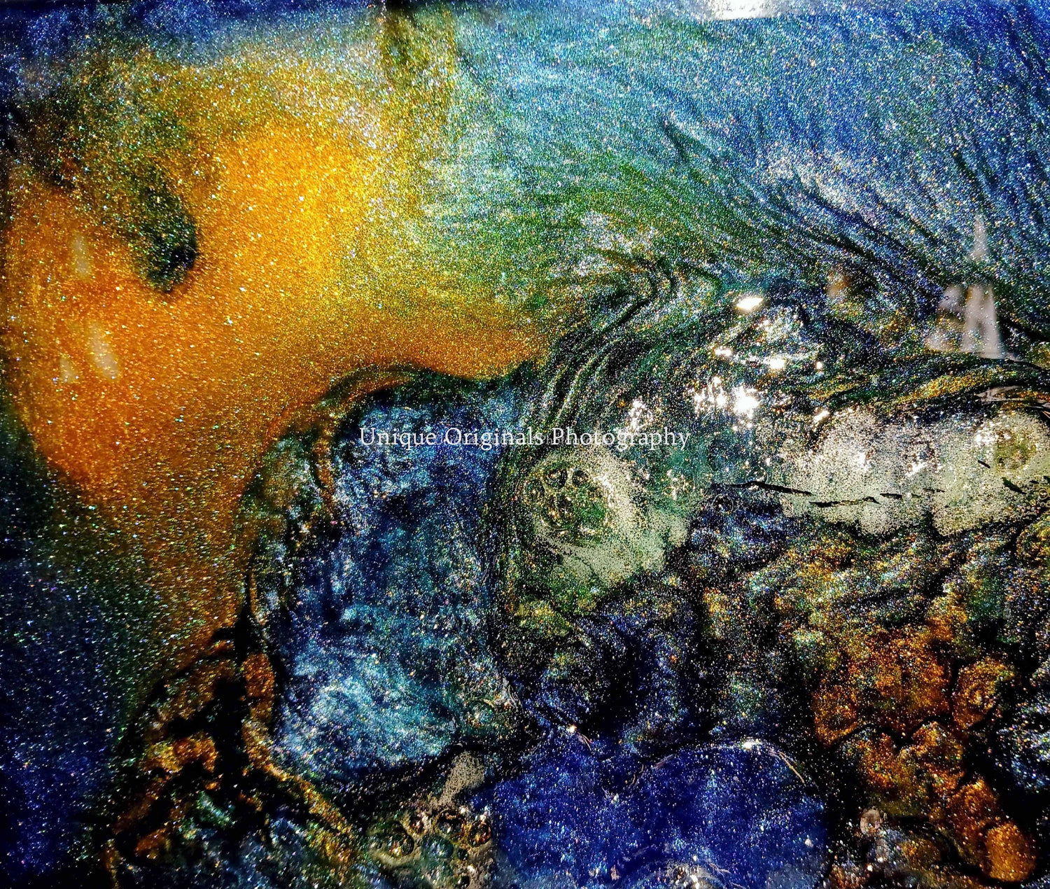 Not unlike a view of a globe, this shows a surrealistic swirl of yellow, blue and white epoxy resin art piece