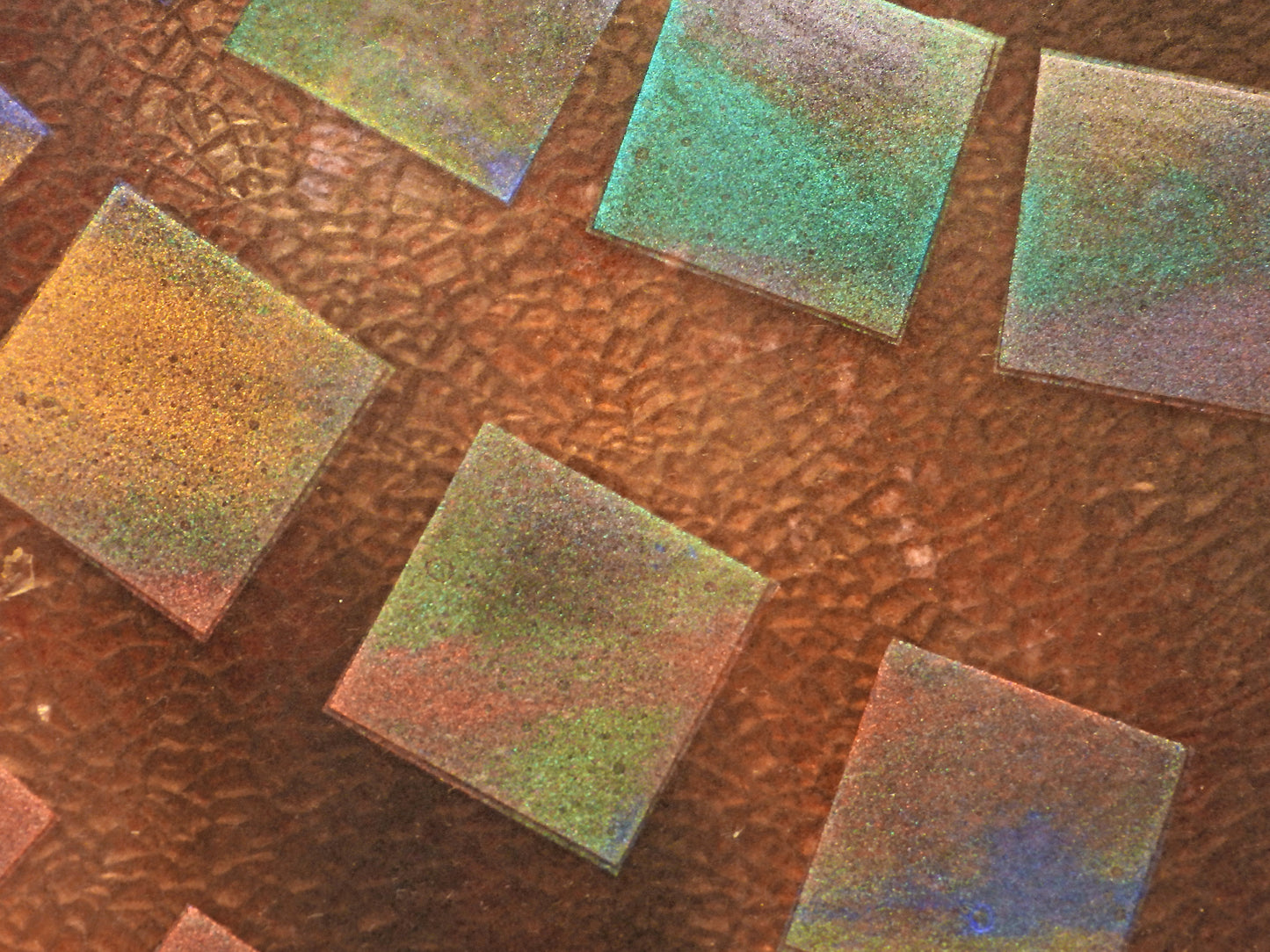 Close-up of square tiles with a textured surface on a brown background