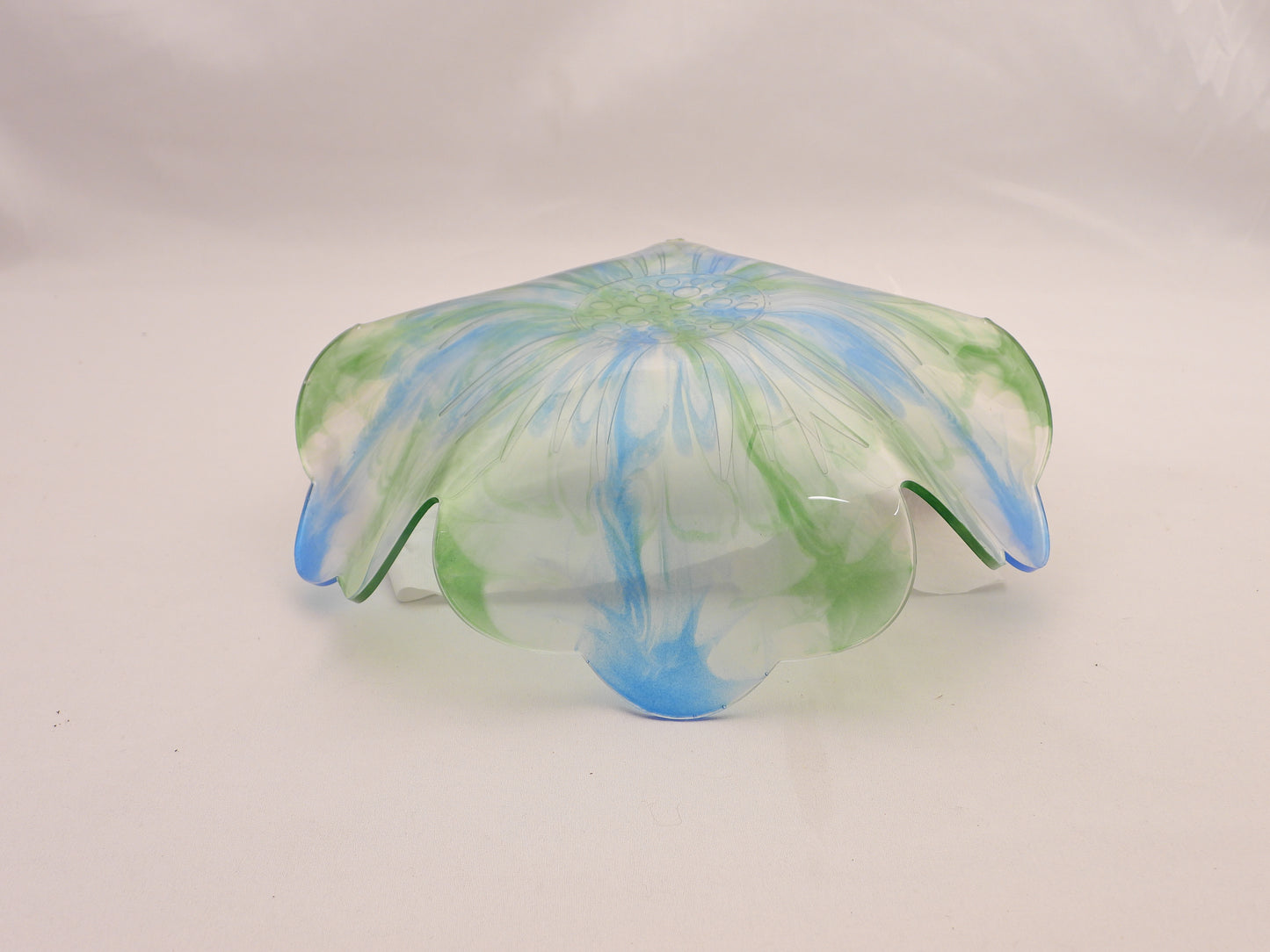 Resin Bowl bottom with green and blue patterns on a white background