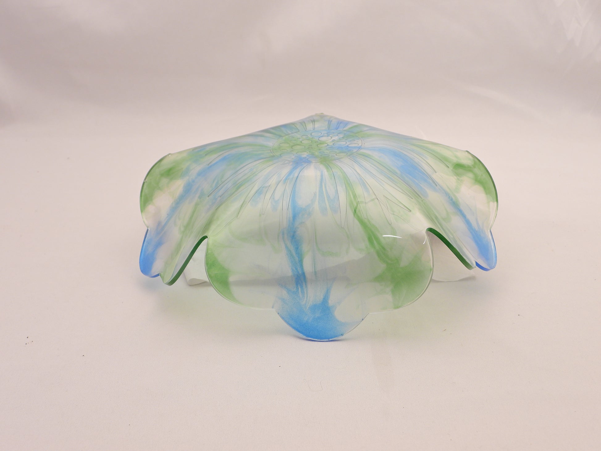 Resin Bowl bottom with green and blue patterns on a white background